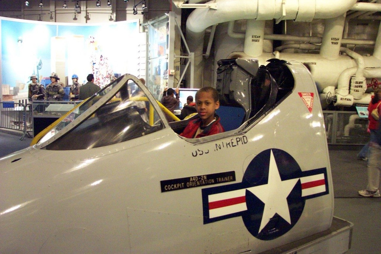 Joe as a kid, sitting in a cockpit at USS Intrepid 