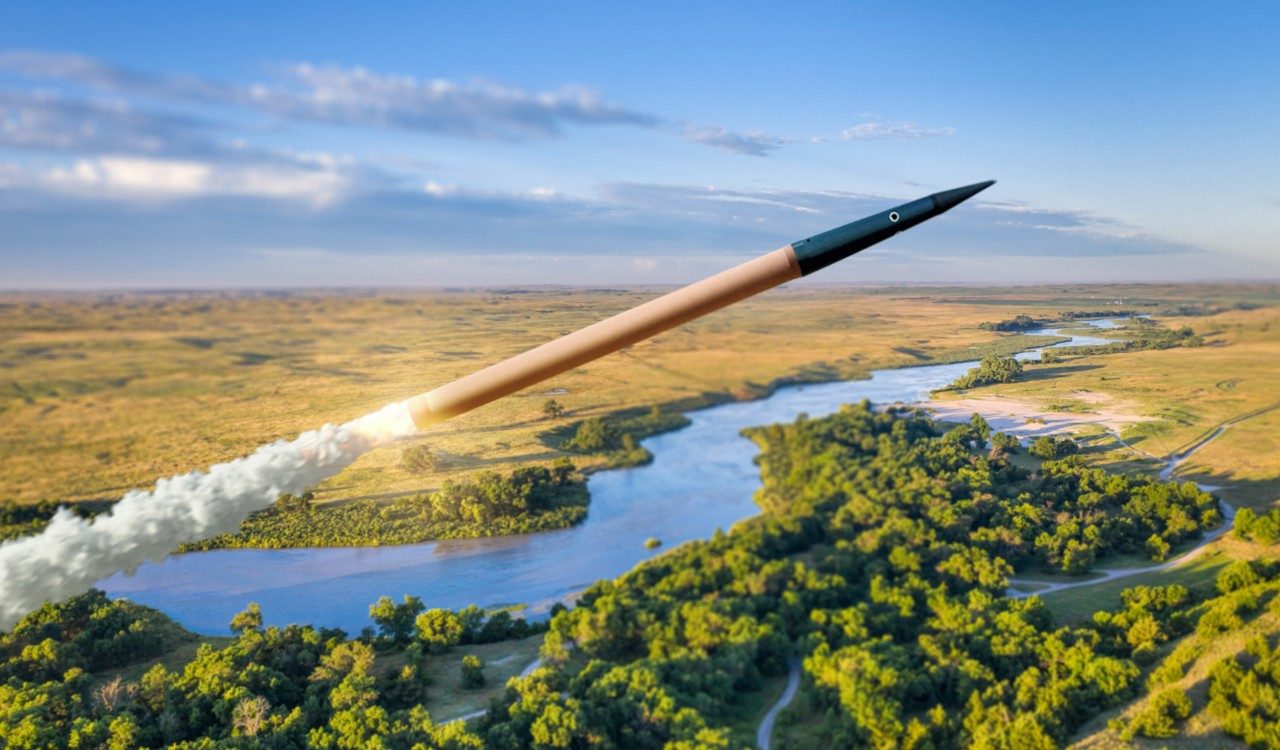Digital rendering of a THAAD missile rocketing over a forested landscape.